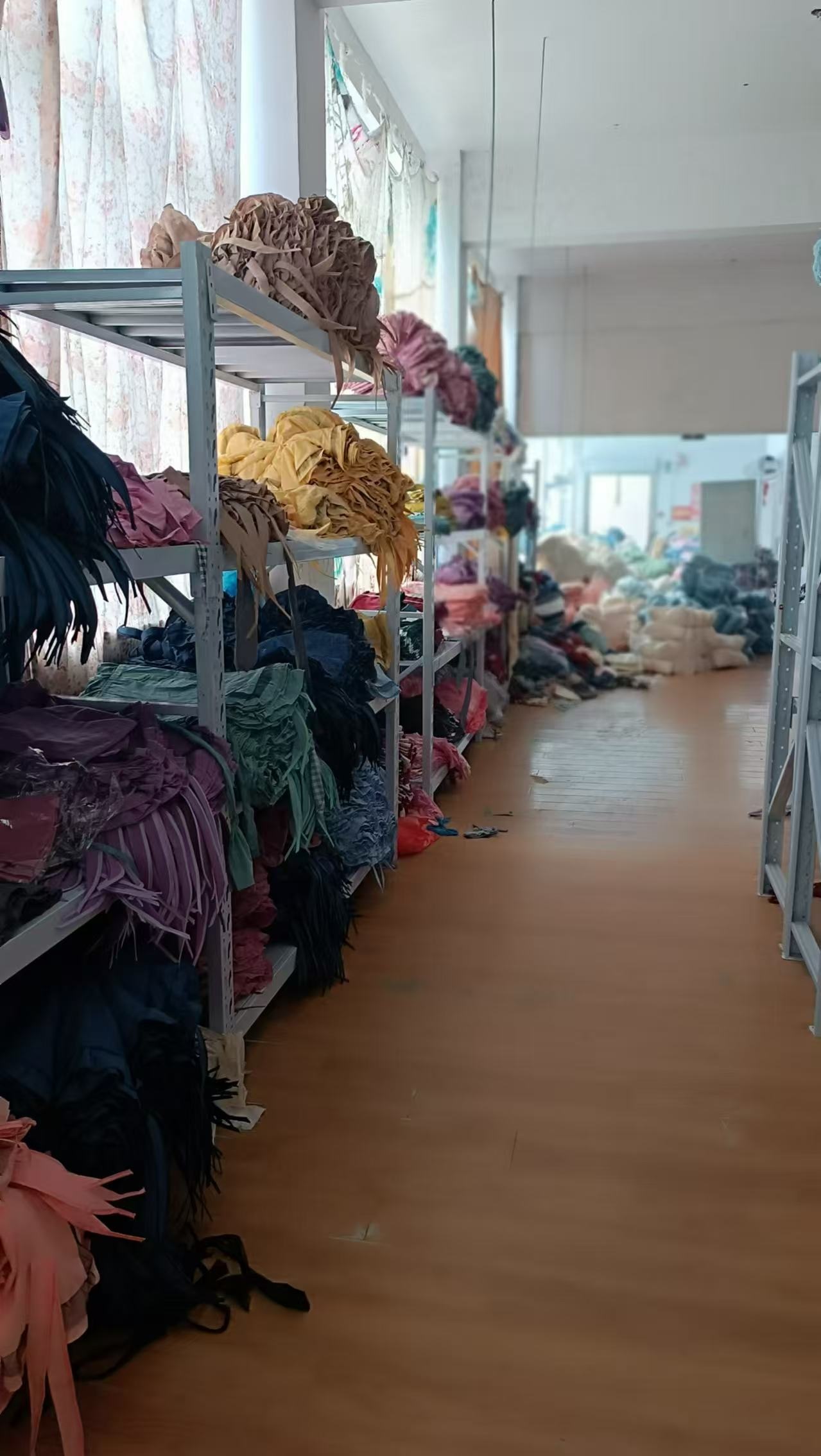 fabric rolls stored along a factory warehouse aisle